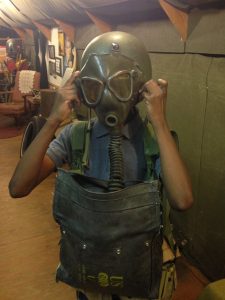 Student trying on D-Day gas mask