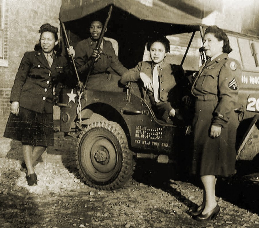 WACs from the 6888th by a jeep
