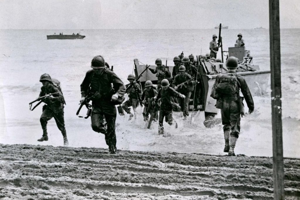 U.S. Marines come ashore from a landing craft on Guadalcanal, August 7, 1942